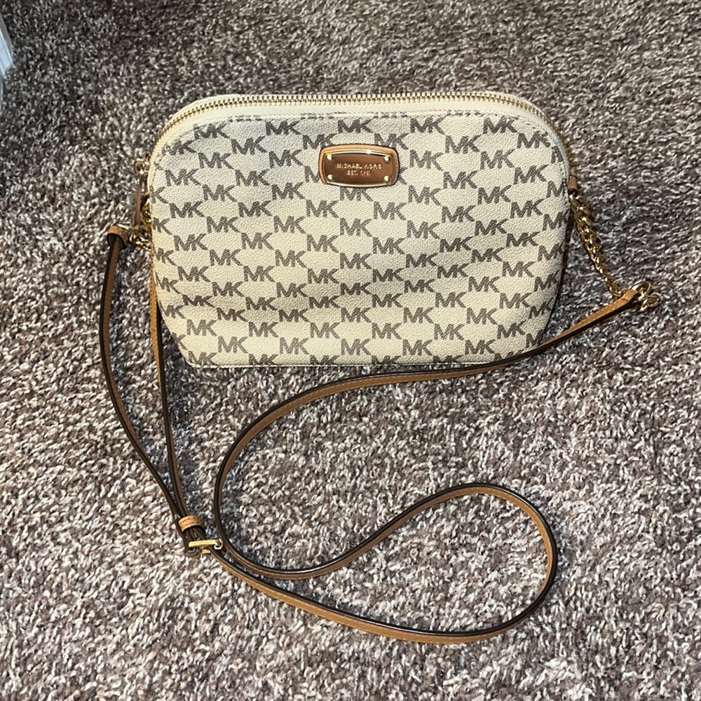 Authentic small brown and tan Michael Kors crossbody purse with gold accents.